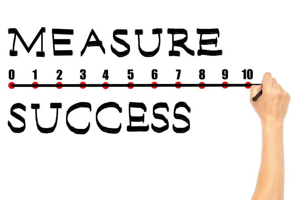 A hand holding a black marker draws a horizontal line across a numerical scale from 0 to 10.