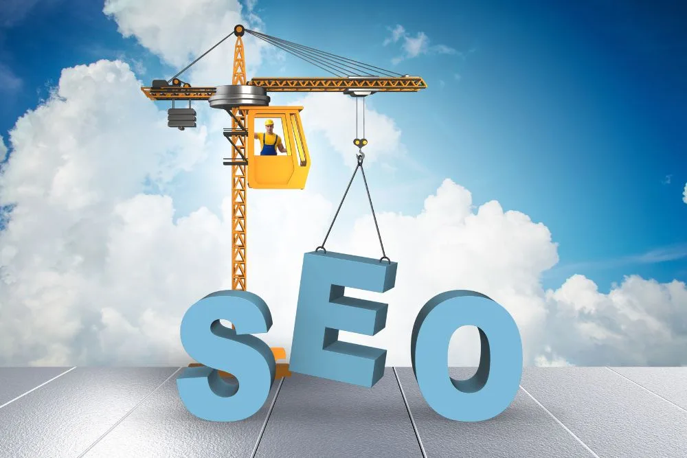 A creative 3D illustration featuring a yellow construction crane lifting a large blue letter "E" to complete the word "SEO."