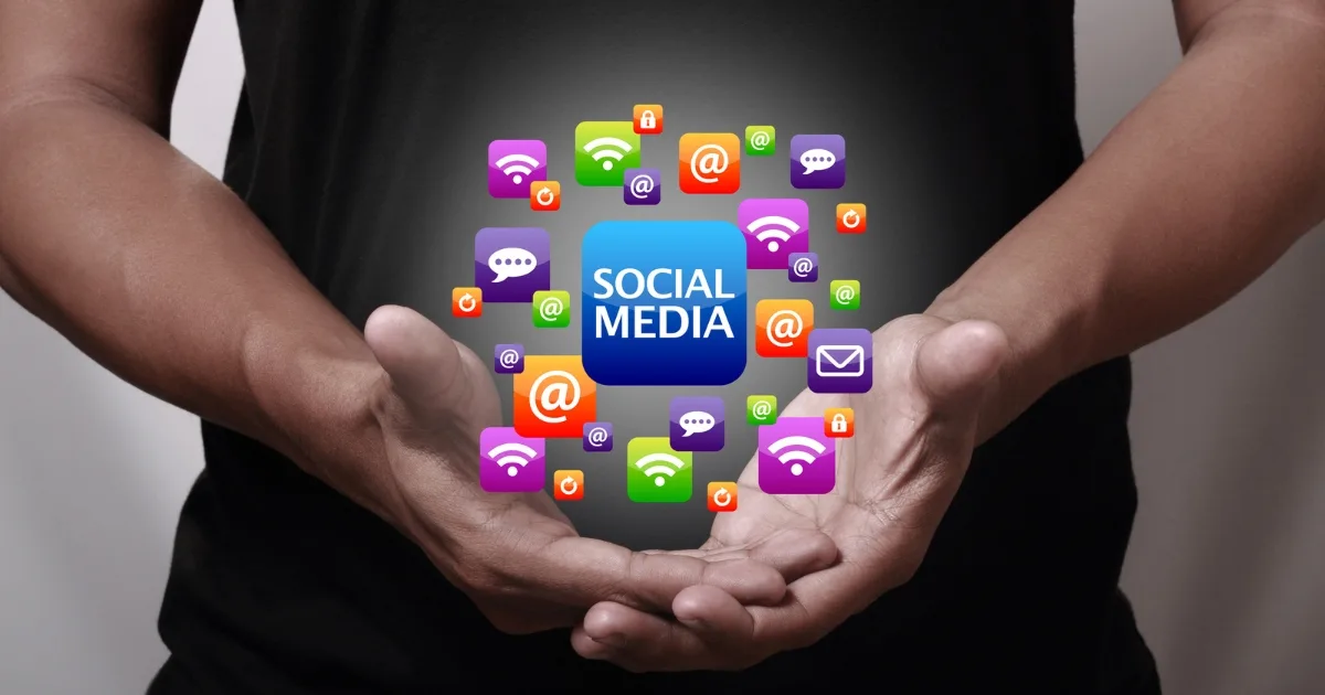 A person's cupped hands holding a glowing 'SOCIAL MEDIA' icon