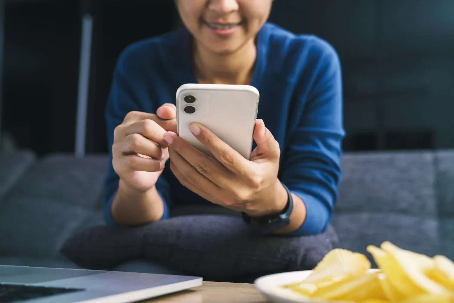 a smiling woman using her phone