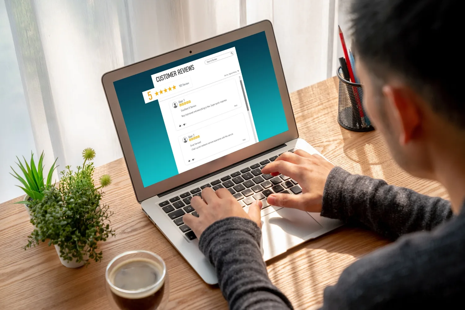A person using a laptop to write a review
