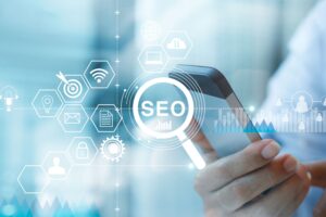 SEO representations with a hand holding phone in the background