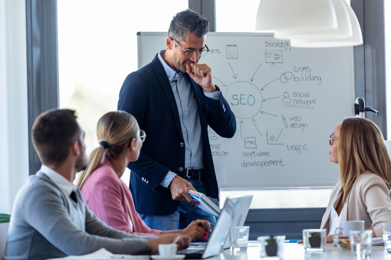 A professional business team holding a meeting in a bright office.