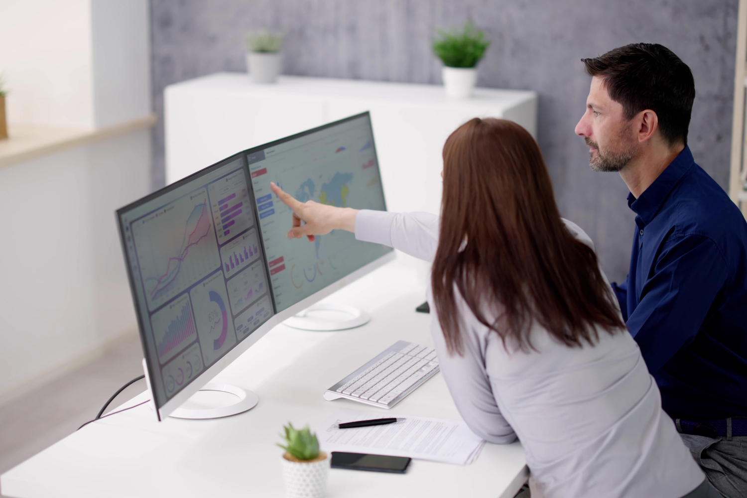 Does My Small Business Need a Custom Web Design? - Business An Australian small business owner reviewing improved website analytics on a laptop at a desk, showing rising traffic, lower bounce rate, and increased enquiry conversions following a custom website redesign