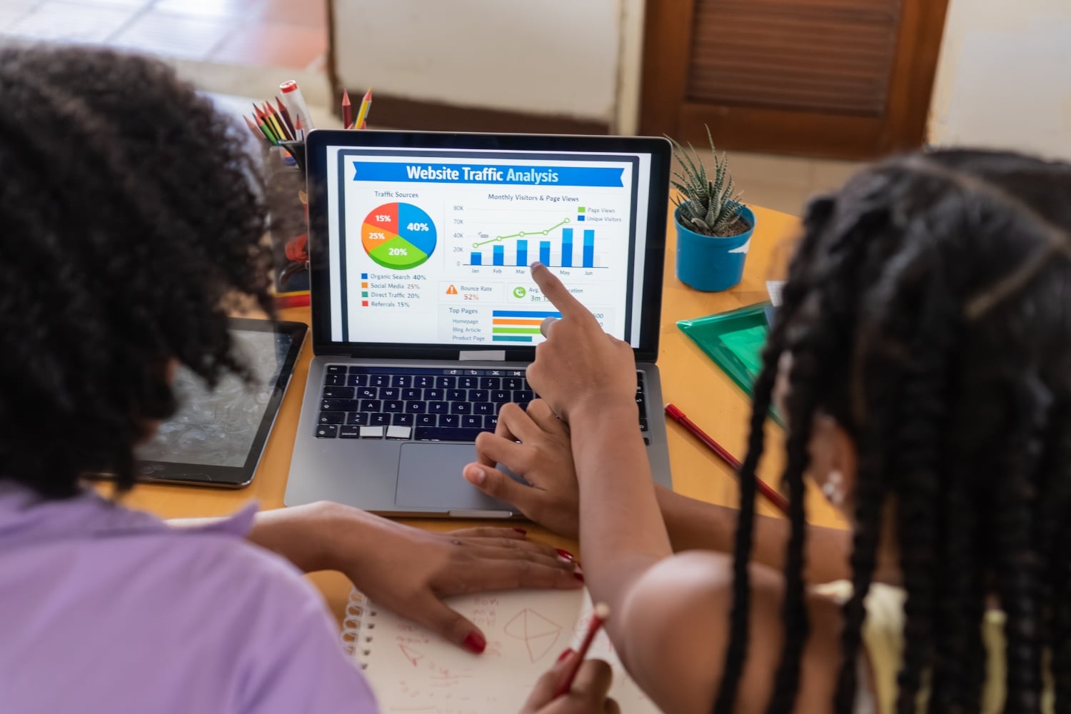 Why Isn’t My Website Ranking on Google? - Website Person pointing at website traffic analysis data on a laptop screen during a technical audit.