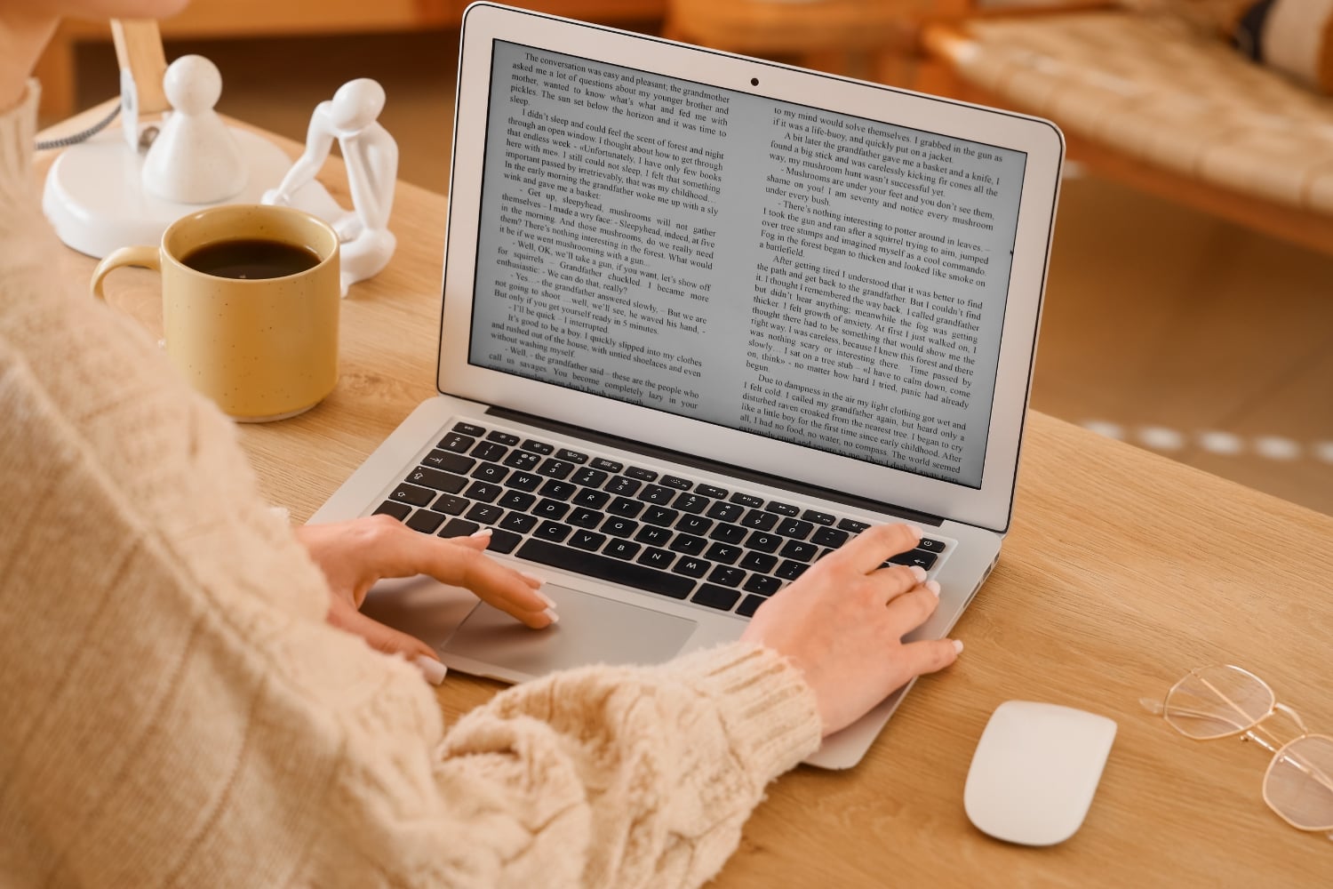 Should I Add a Blog to My Business Website? - Blog An Australian small business owner writing a blog post on a laptop at a tidy desk, with a notebook and coffee beside them, representing the practical reality of maintaining a business blog